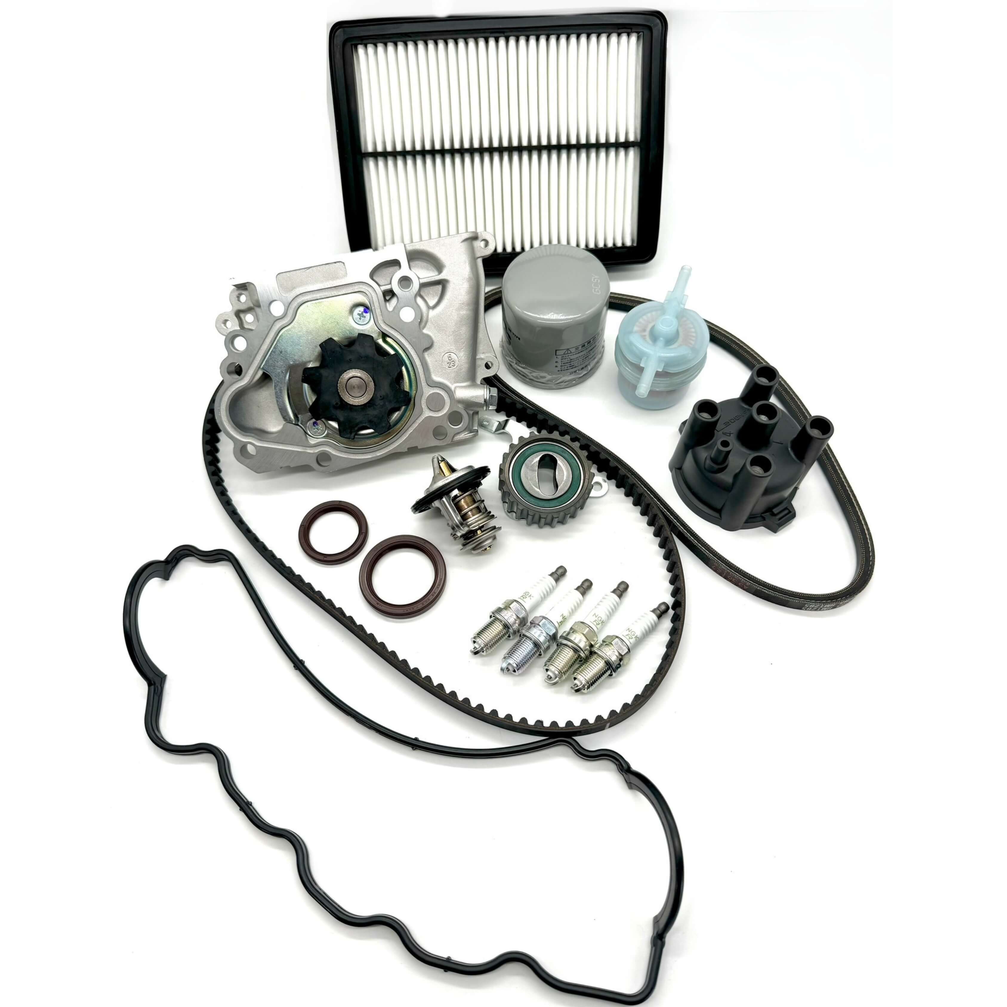 Subaru Sambar KS3 KS4 1990-1998 full 16-piece timing belt kit with timing belt, tensioner pulley, cam and crank seals, water pump, alternator belt, thermostat, valve cover gasket, oil, fuel, and air filters, spark plugs, distributor cap for comprehensive engine maintenance.