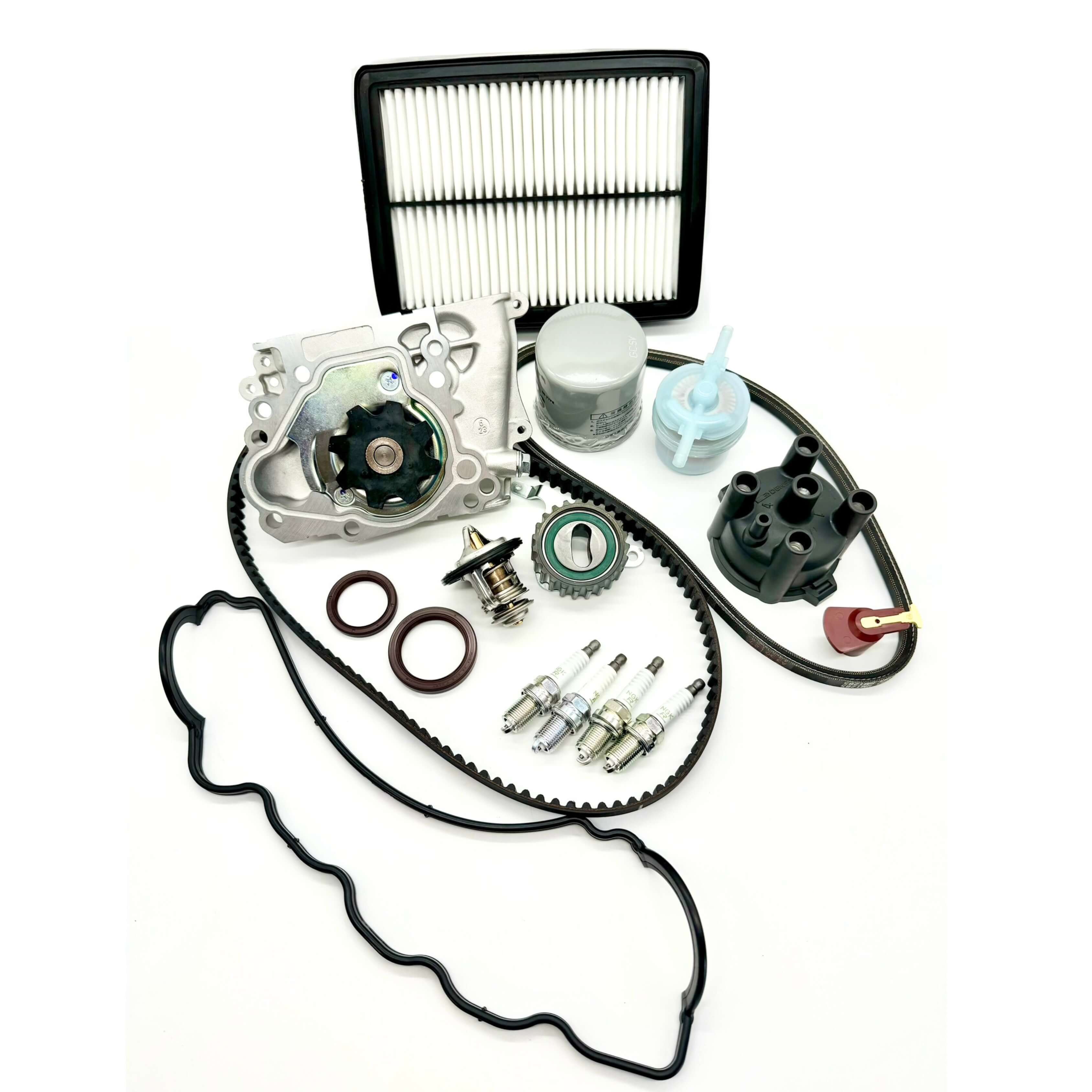 Subaru Sambar KV3 KV4 1990-1998 comprehensive 17-piece timing belt kit with timing belt, tensioner pulley, cam and crank seals, water pump, alternator belt, thermostat, valve cover gasket, oil, fuel, and air filters, spark plugs, distributor cap, and rotor for complete engine overhaul.