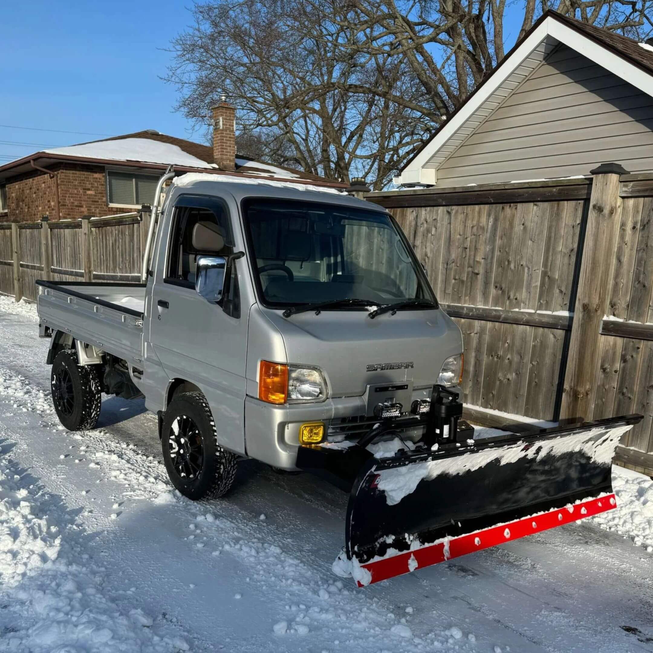 Silver Subaru Sambar mini truck with snow plow attached to Armor Front Bumper.