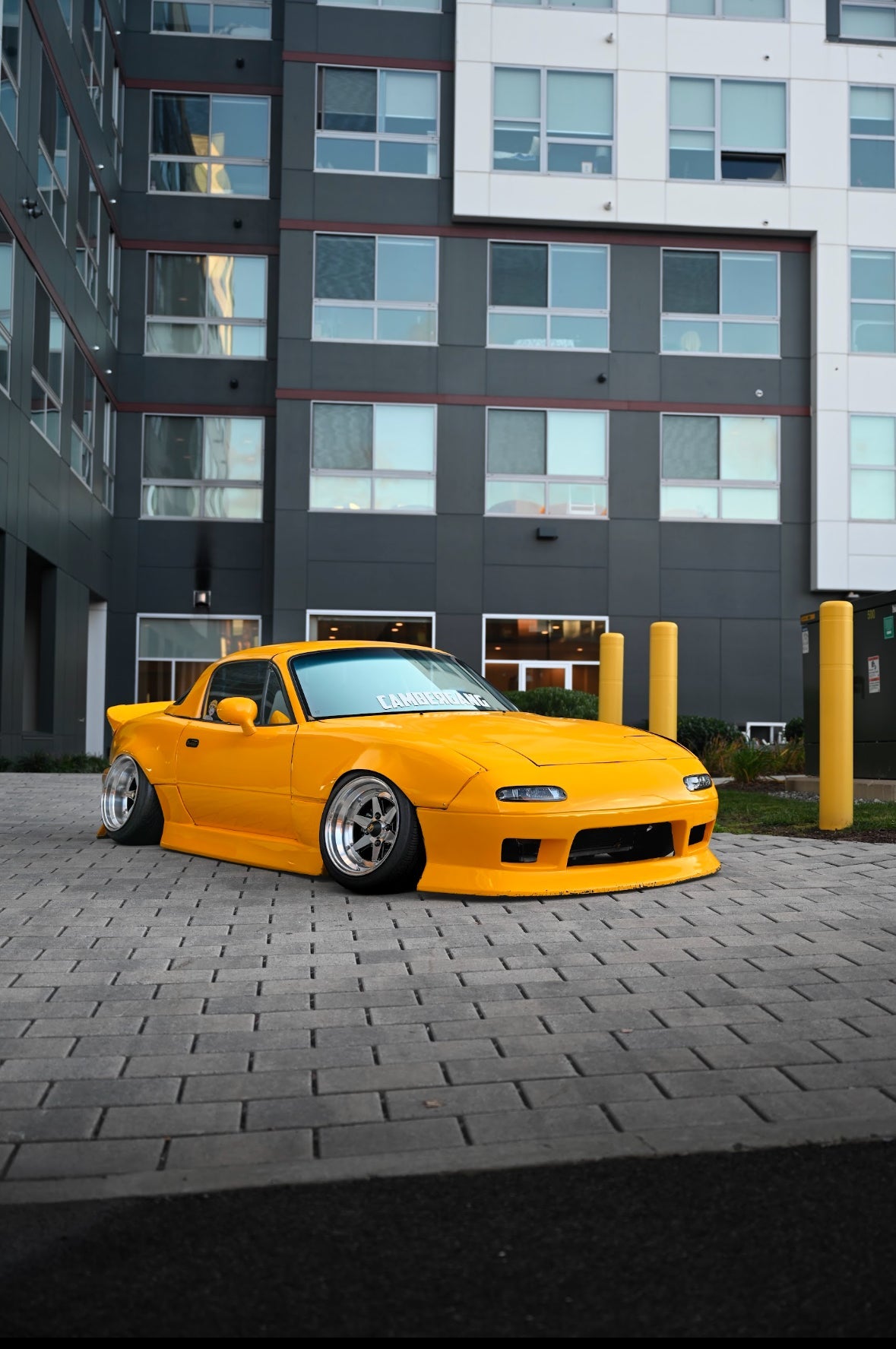 Orange Mazda Miata with Omnique's Neo Silver tint, delivering a sleek, modern mirror finish.