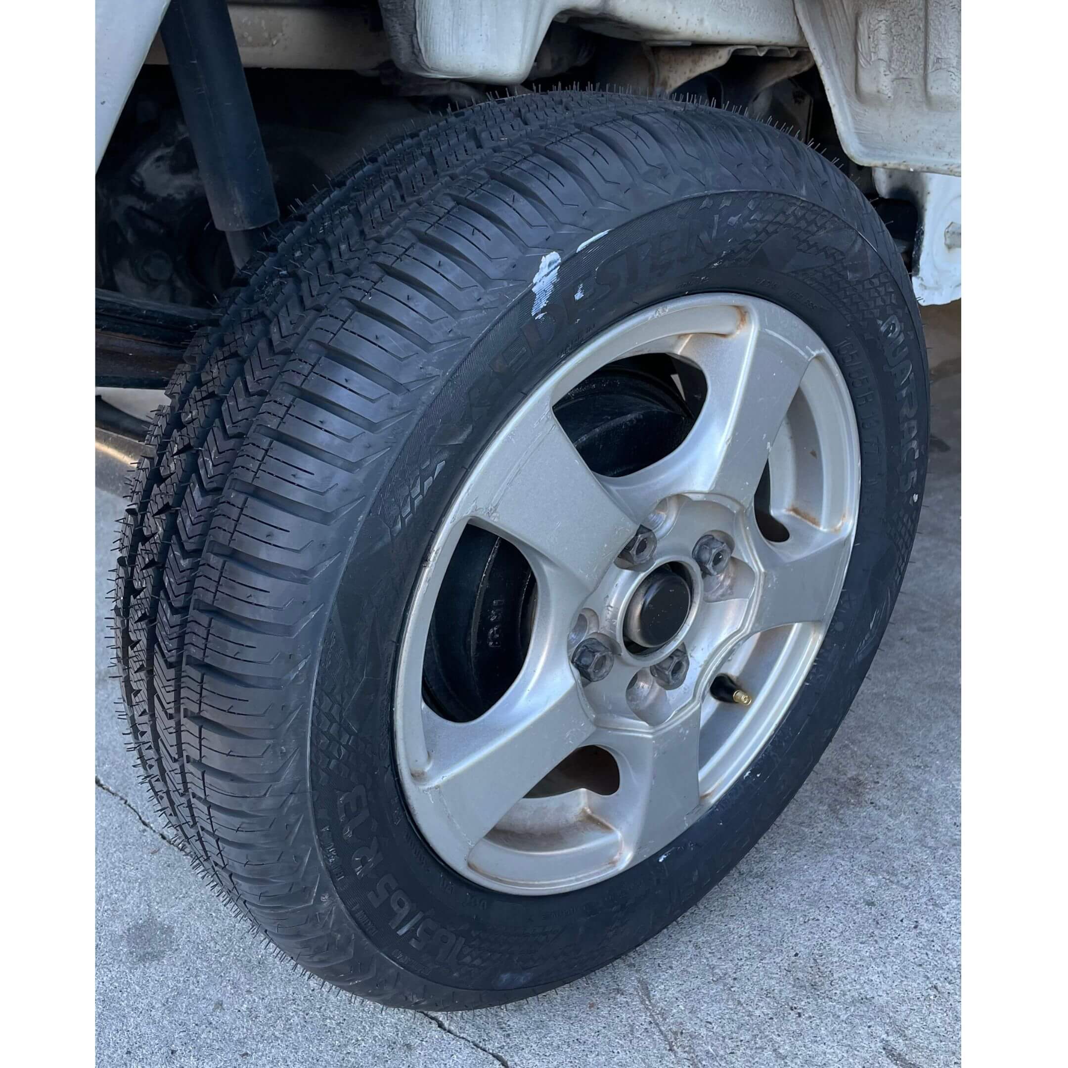 Close-up view of alloy wheel and tire tread on 1994 Honda Acty Town 4WD Kei Truck, clearly showing excellent tire condition and rim detail.