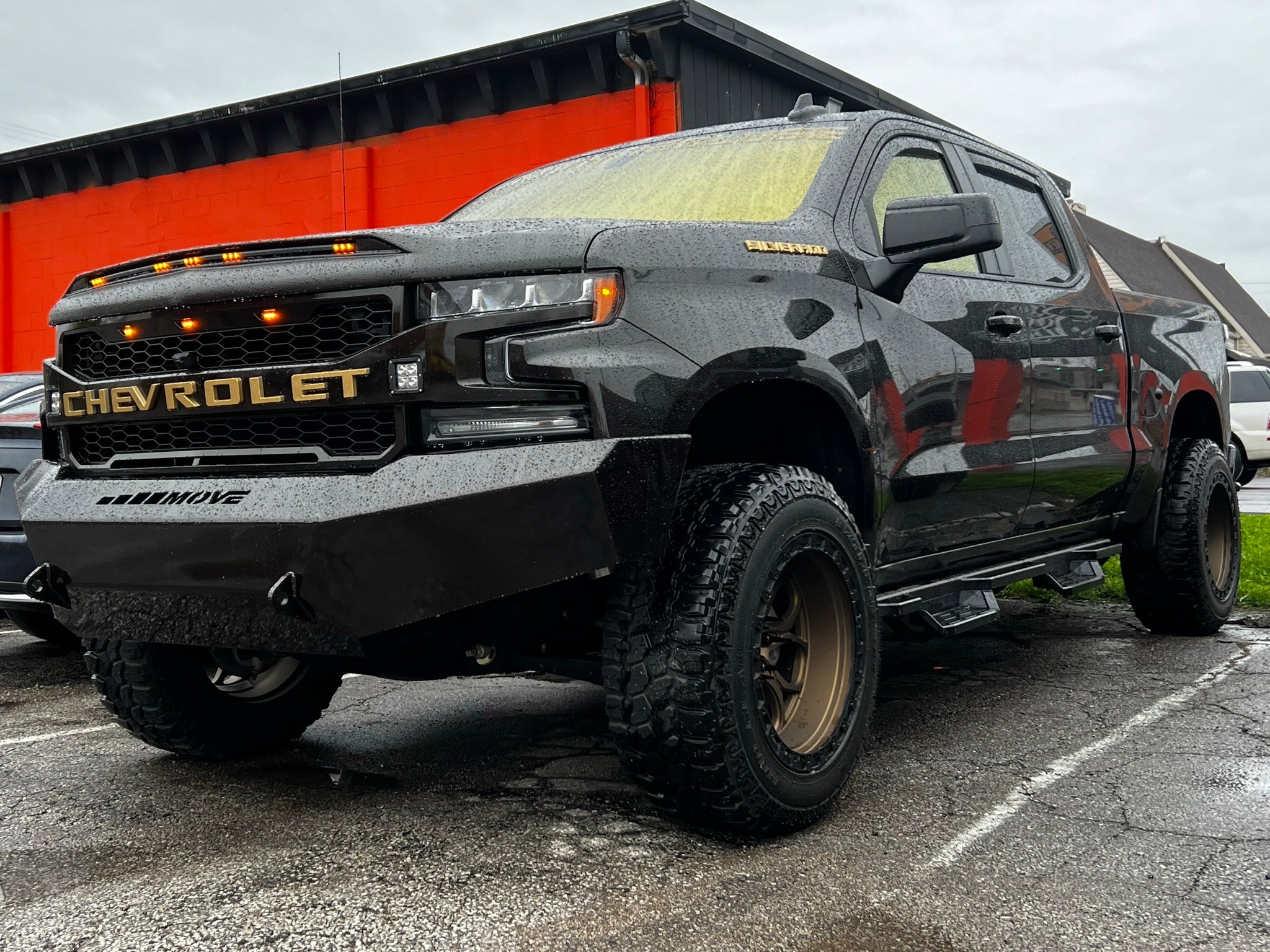 Off-road truck with Omnique Phantom Gold tint, offering full UV and heat protection with a striking gold reflection.