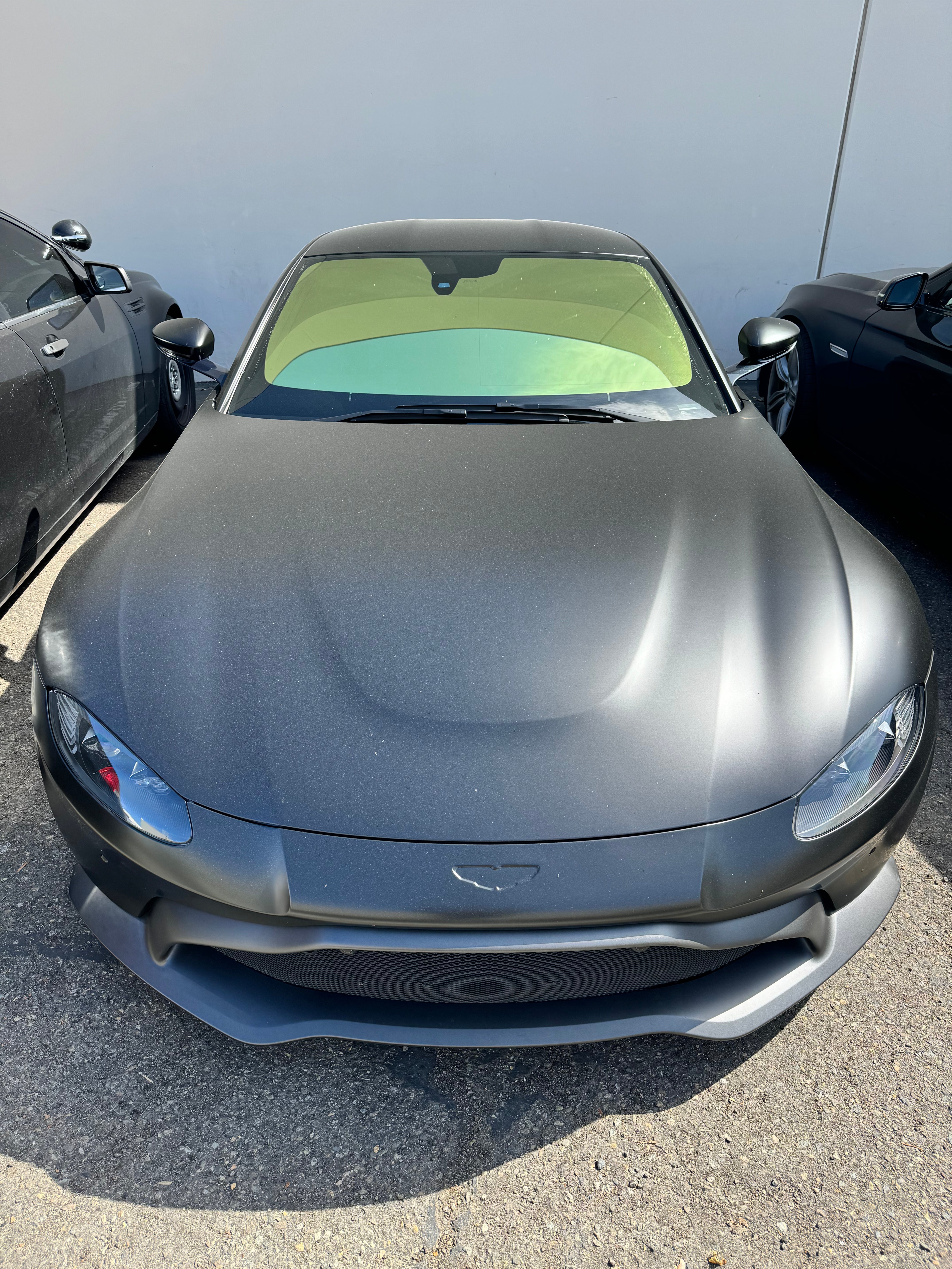 Front view of a sports car with Omnique Phantom Gold tint applied to the windshield, showcasing its light-gold reflection.