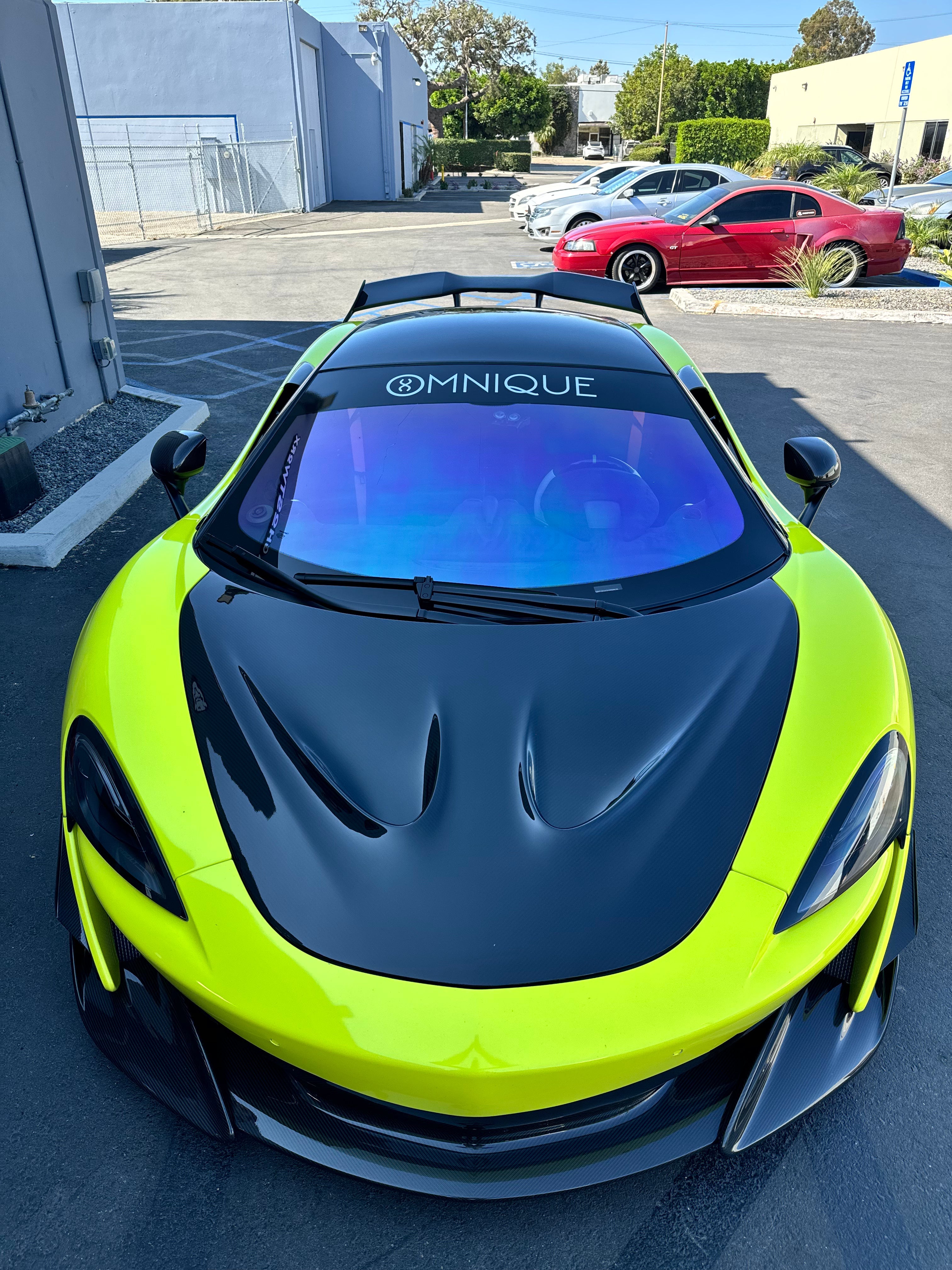 Omnique IOLITE tint installed on a sports car, delivering a luxury aesthetic with shades of blue, purple, and red.