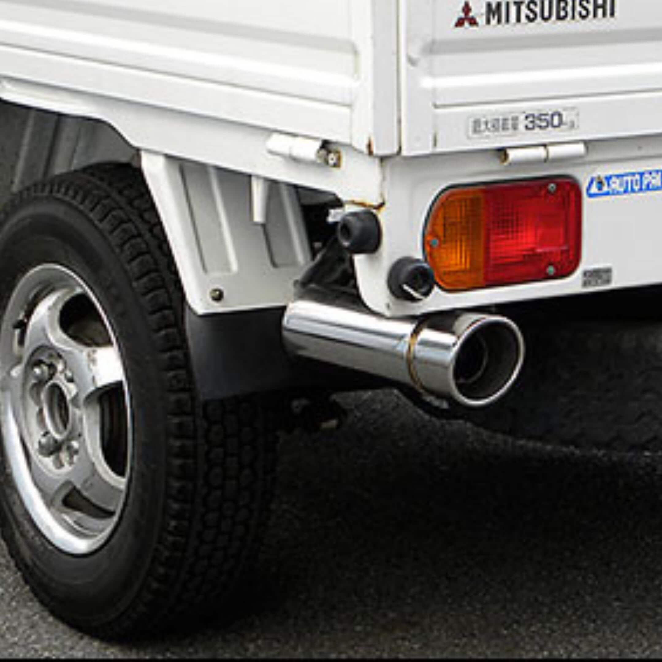 Mitsubishi Minicab U41T/U42T (1990–1999) aftermarket stainless-steel exhaust with polished single-tip muffler mounted under rear cargo bed for enhanced flow and sound – Exhausts collection.