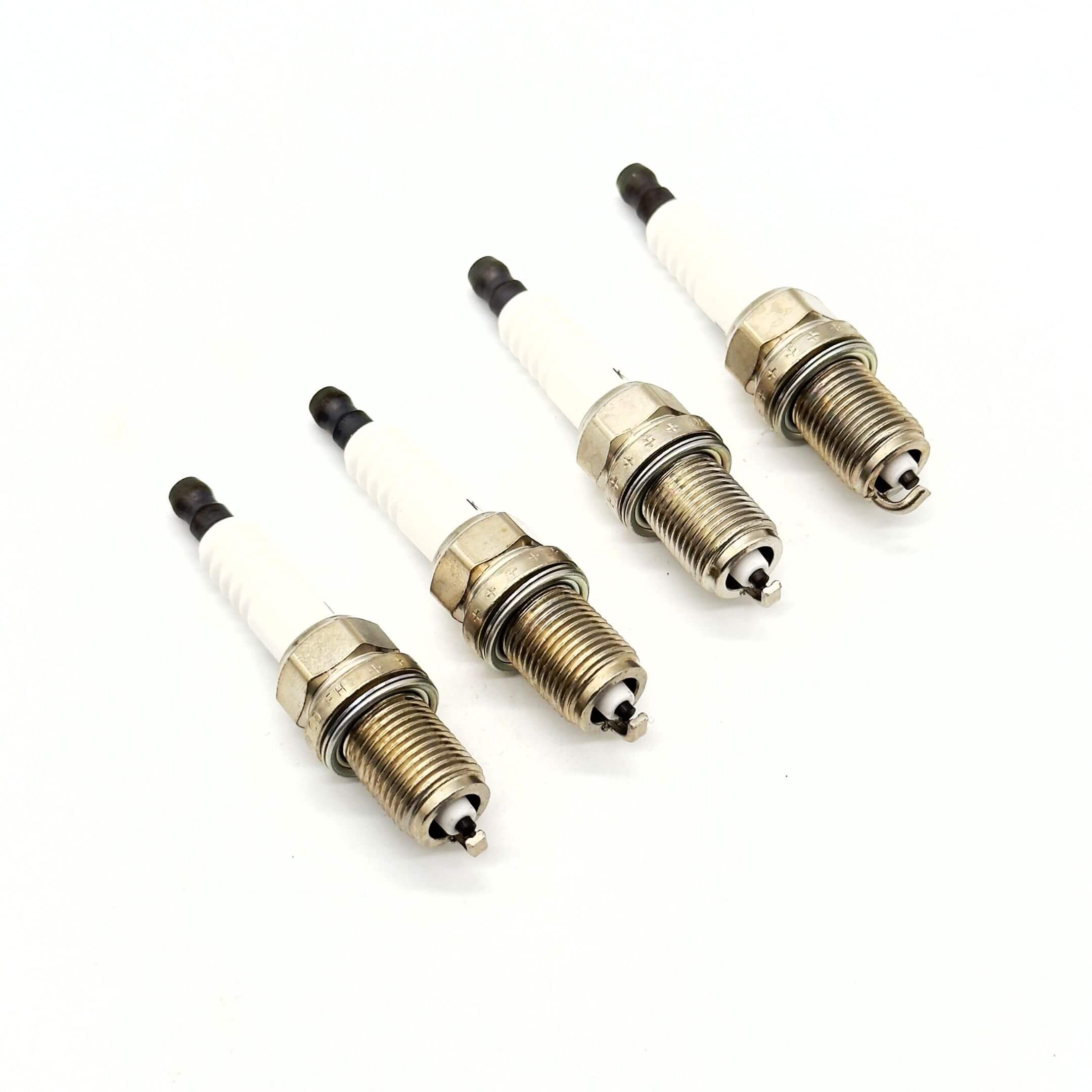 Subaru Sambar Truck TT1, TT2 "Red Hat" spark plugs for models from 2/1999 to 8/2001, featuring a durable metal and ceramic design.