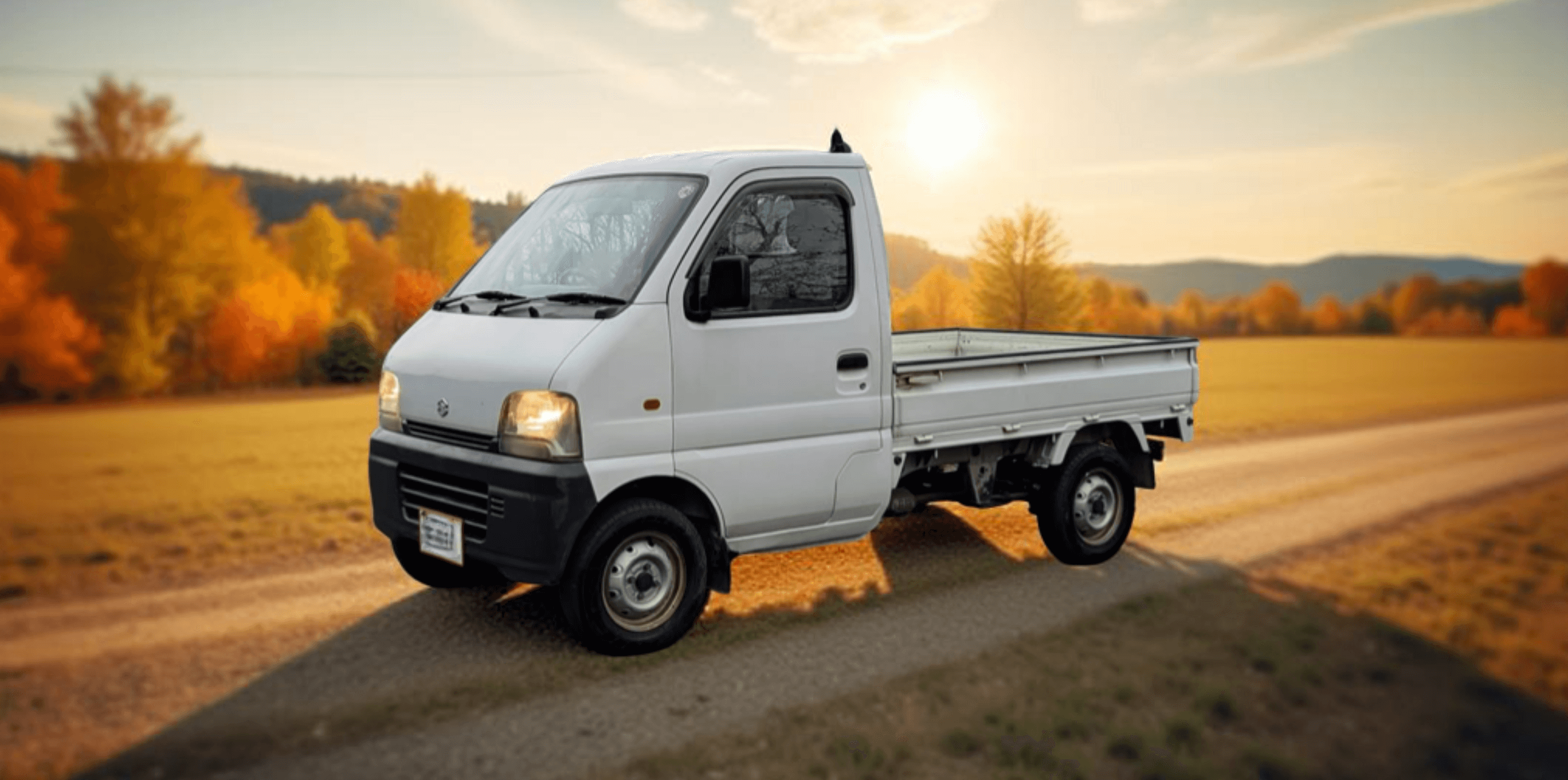 White Suzuki Carry Truck DA52T, DB52T (1998-2001) Kei Truck on Scenic Country Road – Essential Parts, Accessories & Upgrades for Reliability and Performance