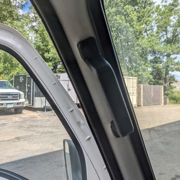 Subaru Sambar Interior Grab Handle for TW1, TW2 Models (1999-2012), black, mounted on door frame.