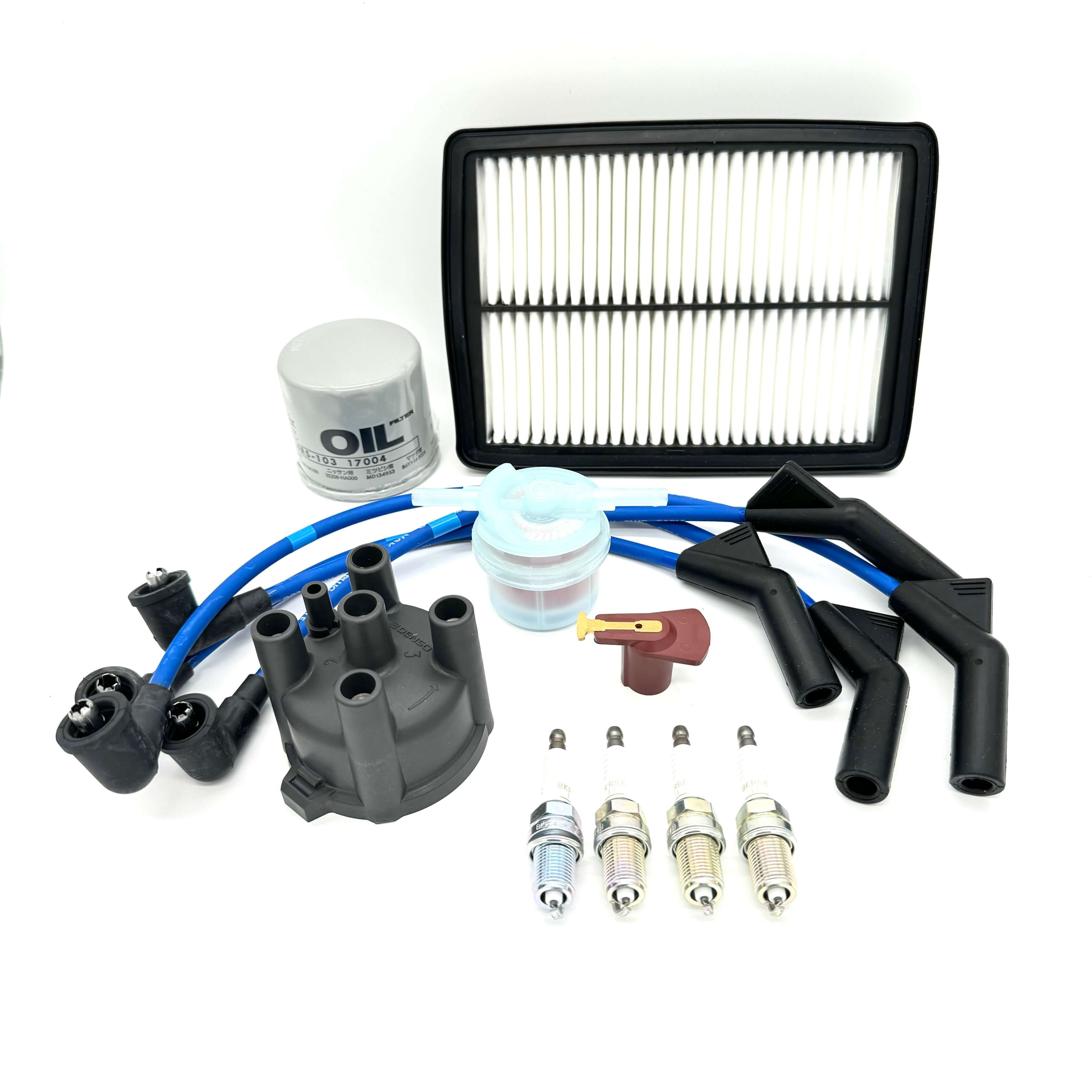 Complete 13-piece ignition tune-up kit for Subaru Sambar KV3 KV4 1990-1998, featuring high-quality distributor cap, rotor, spark plugs, blue silicone wires, oil filter, fuel filter, and air filter components, all arranged neatly on a white background for Oiwa Garage's e-commerce site specializing in Japanese mini Van parts.