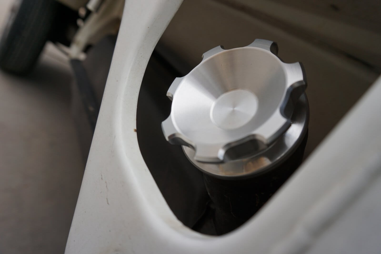 Crown gas cap for Honda Acty Truck, silver aluminum with a textured grip, installed on a white vehicle background