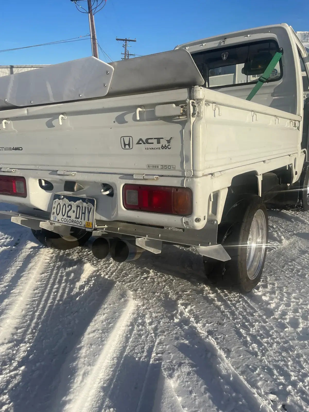 Rear diffuser for Honda Acty Truck HA3, HA4 models, 1990-1999, in silver, mounted on a white truck in snowy setting