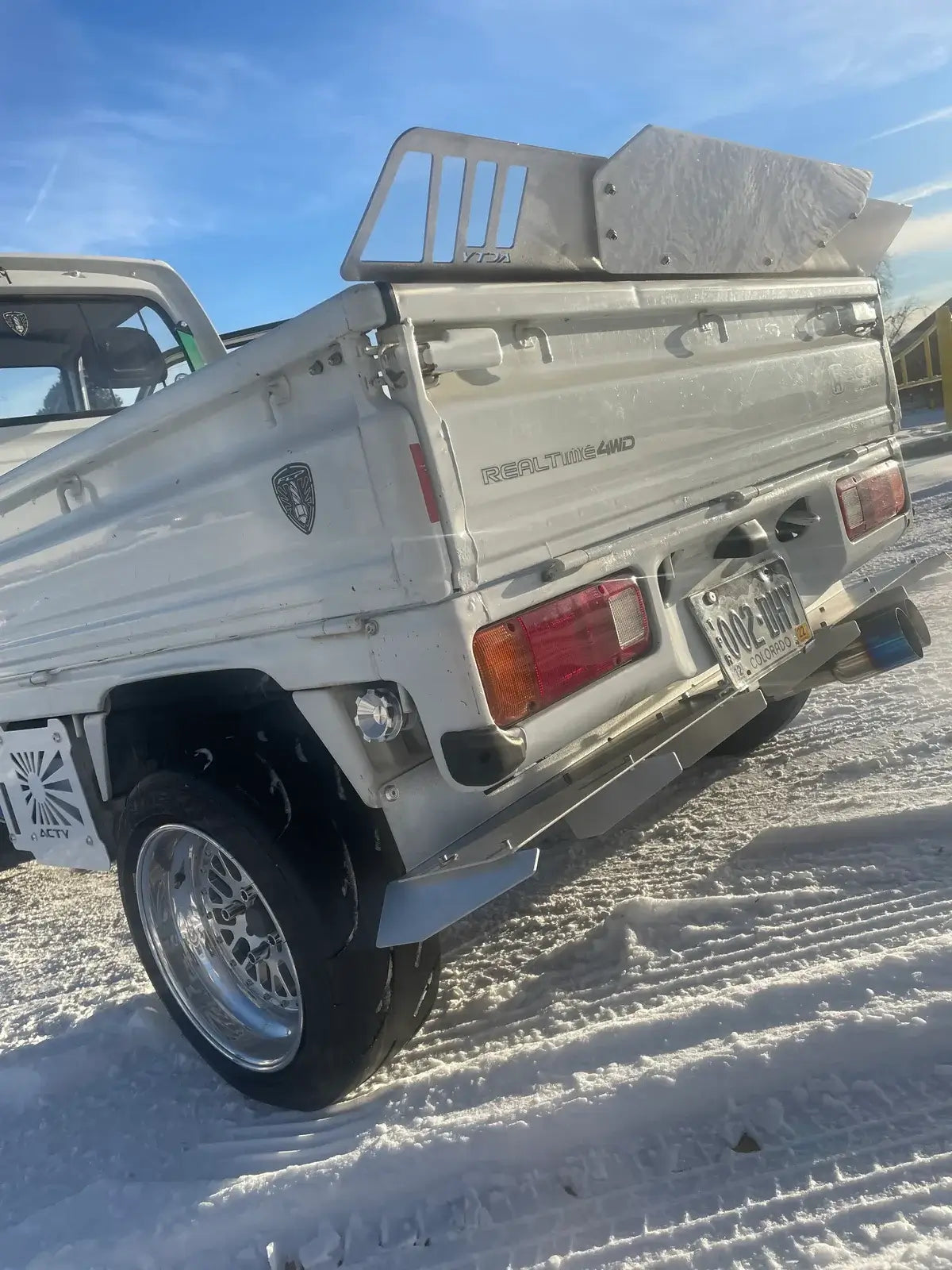 Rear diffuser for Honda Acty Truck HA3, HA4 models, 1990-1999, featuring a sleek silver design against a snowy backdrop
