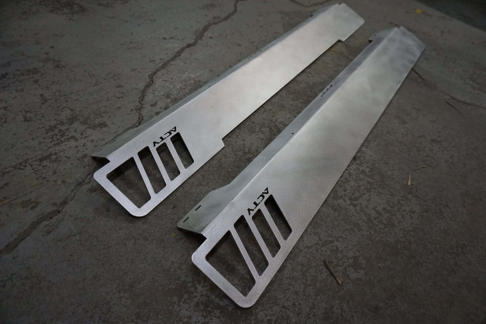 Rear Lusso Spoiler for Honda Acty Truck, silver aluminum, sleek design, angled view on a textured gray surface