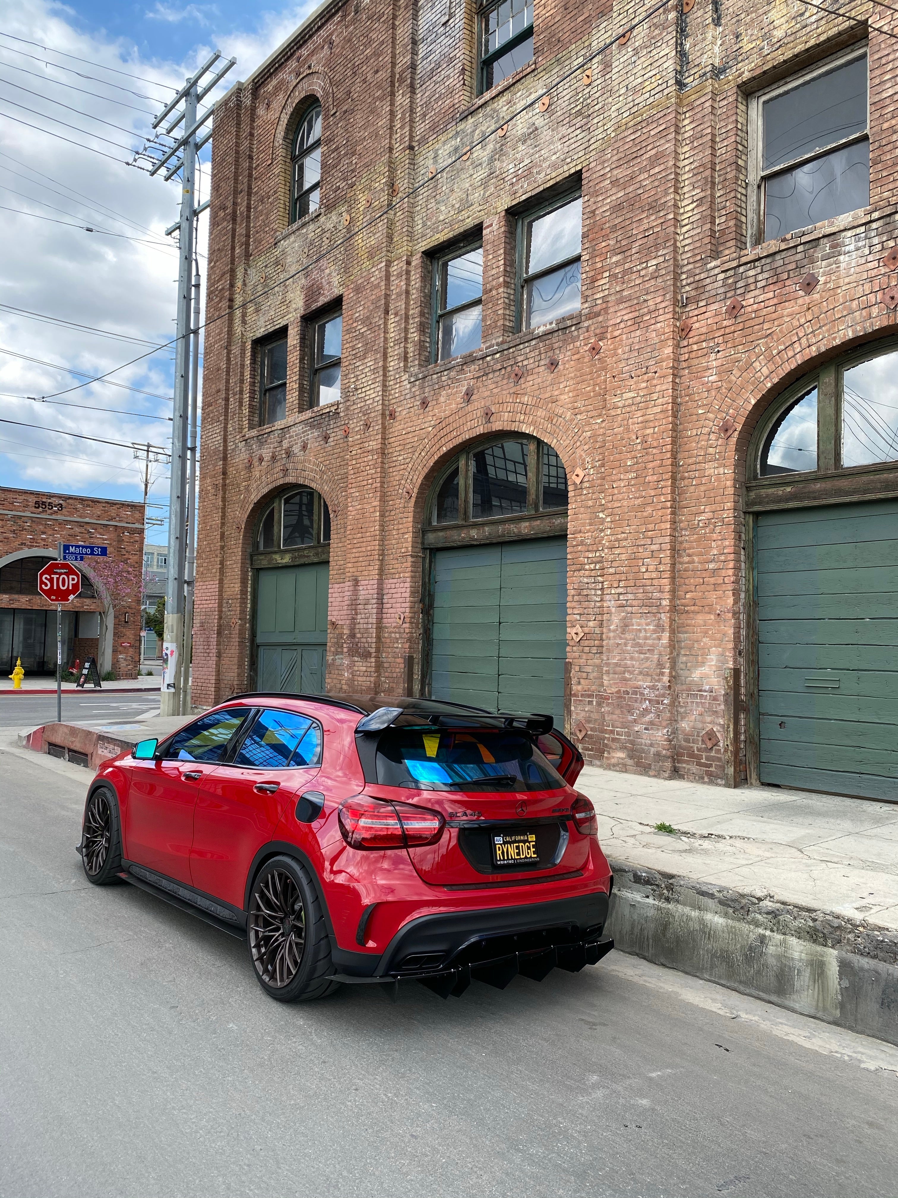 Opal ceramic tint by Omnique on a red luxury vehicle, offering a rich display of shifting colors from blue to turquoise.