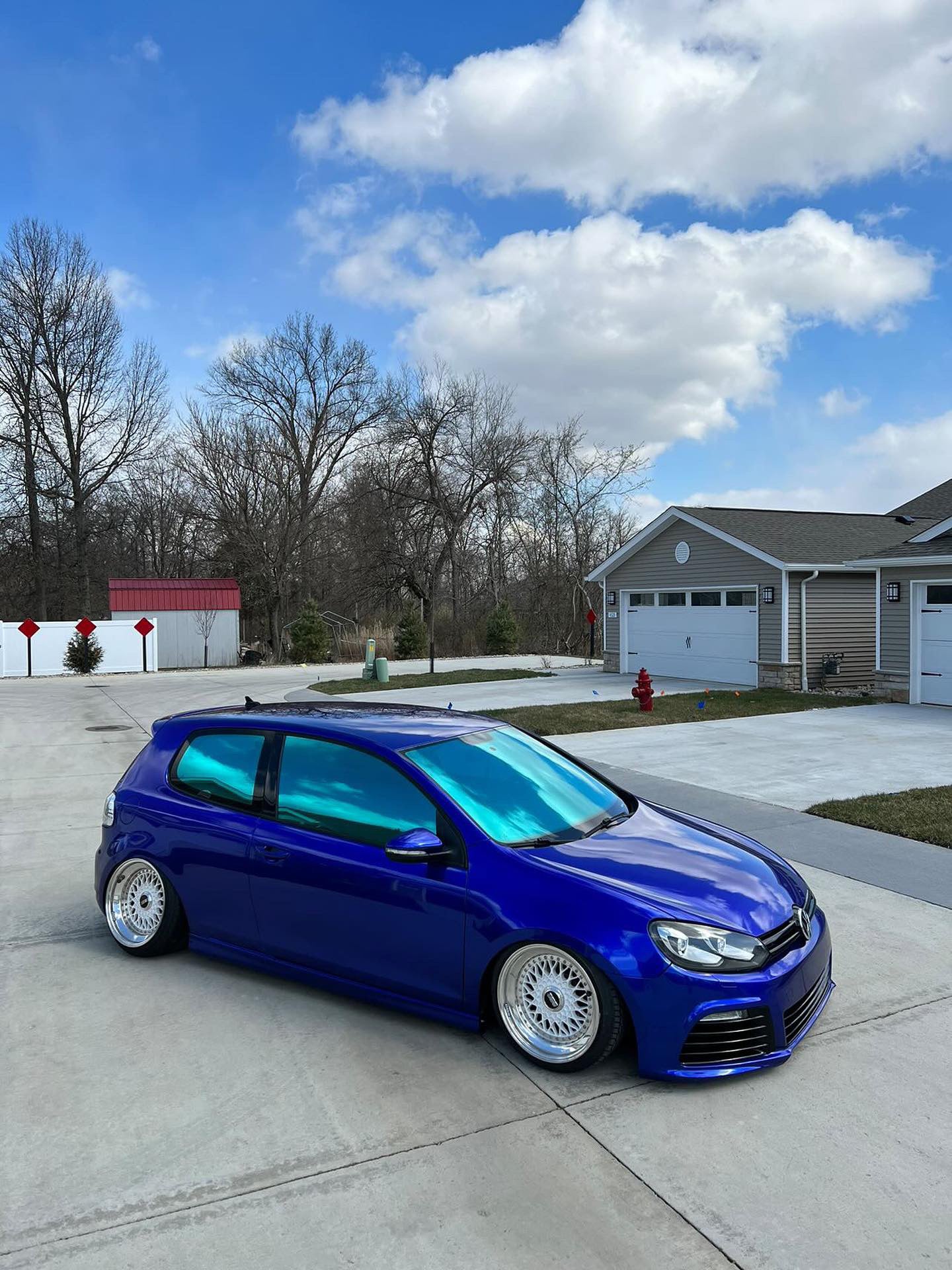 Volkswagen Golf featuring Omnique Design Bellagio Blue tint on side windows, offering a modern blue finish.