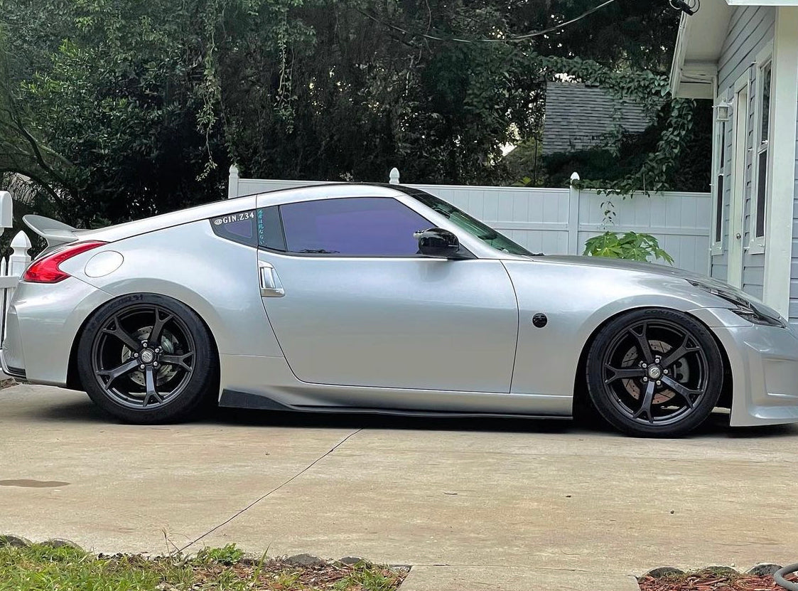 Silver Nissan with Omnique Amethyst Purple Tint – Omnique reflective purple tint on a silver Nissan for UV protection and style.