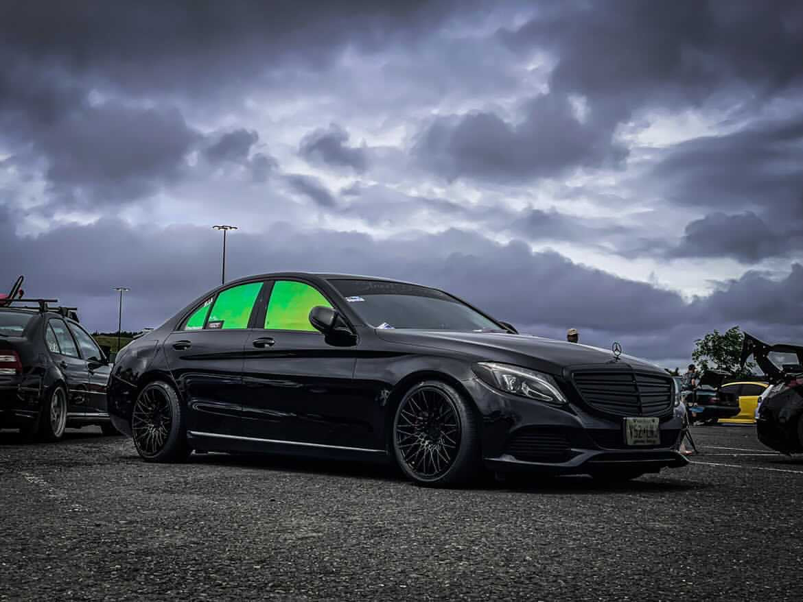 Mercedes Sedan with Omnique Aurora Colorshift Tint - Sleek Black Car with Green and Yellow Tint on Windows.