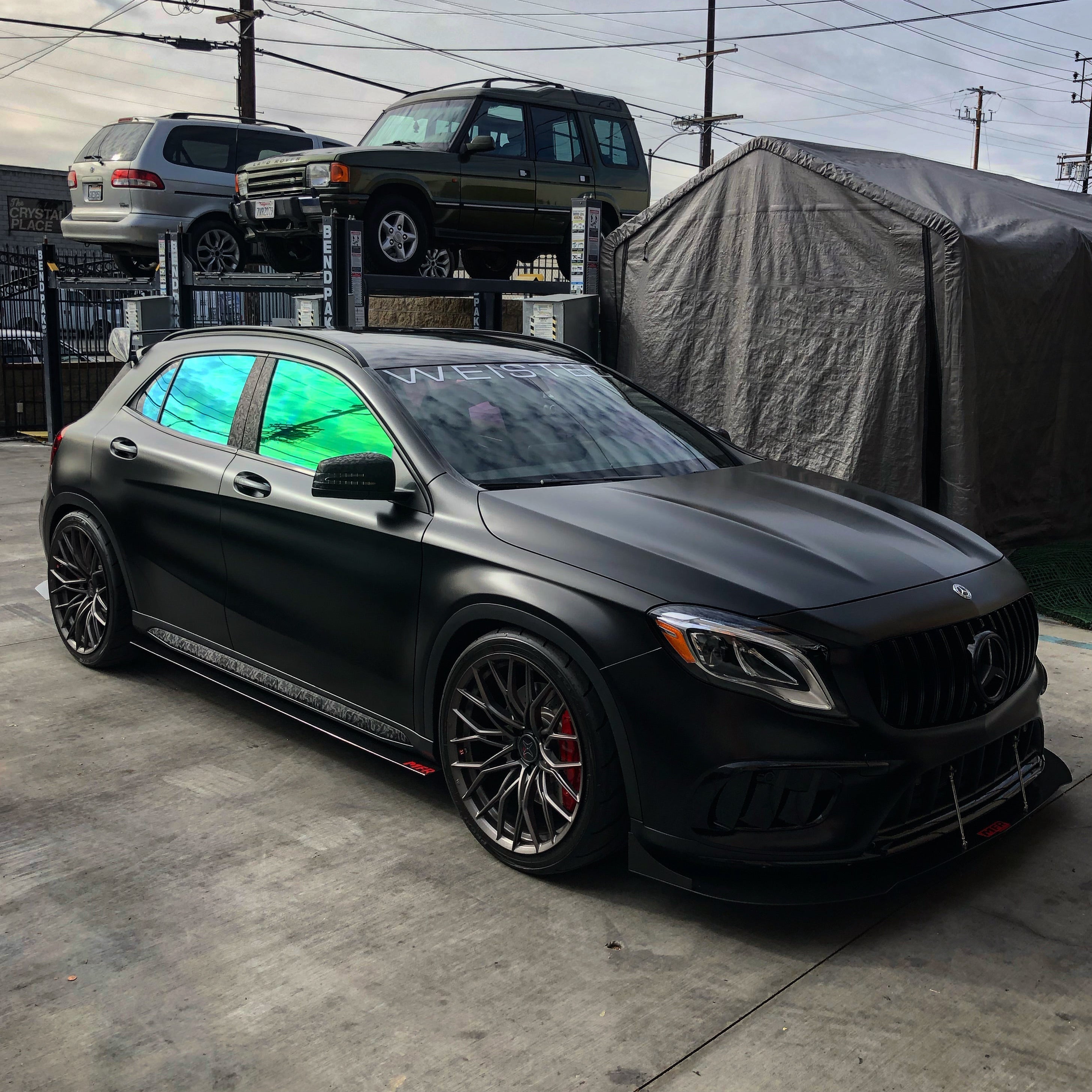 Mercedes SUV with Omnique Aurora Colorshift Tint - Bold Green-Blue Iridescent Tint on Side Windows.