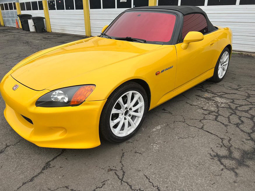 Bright red tint applied to a yellow sports coupe, showcasing the vibrant Vulcan Red tint by Omnique.