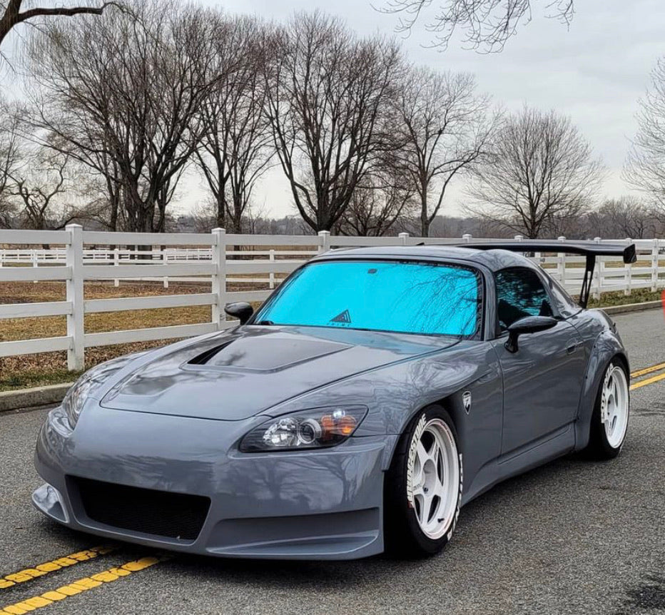 Honda S2000 with Omnique Design Bellagio Blue tint, enhancing the vehicle’s sleek aesthetic with UV protection.