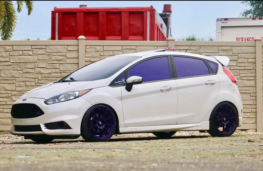 White Hatchback with Omnique Amethyst Purple Tint – Omnique ultra-dark purple tint on a white hatchback, ensuring privacy and UV protection.