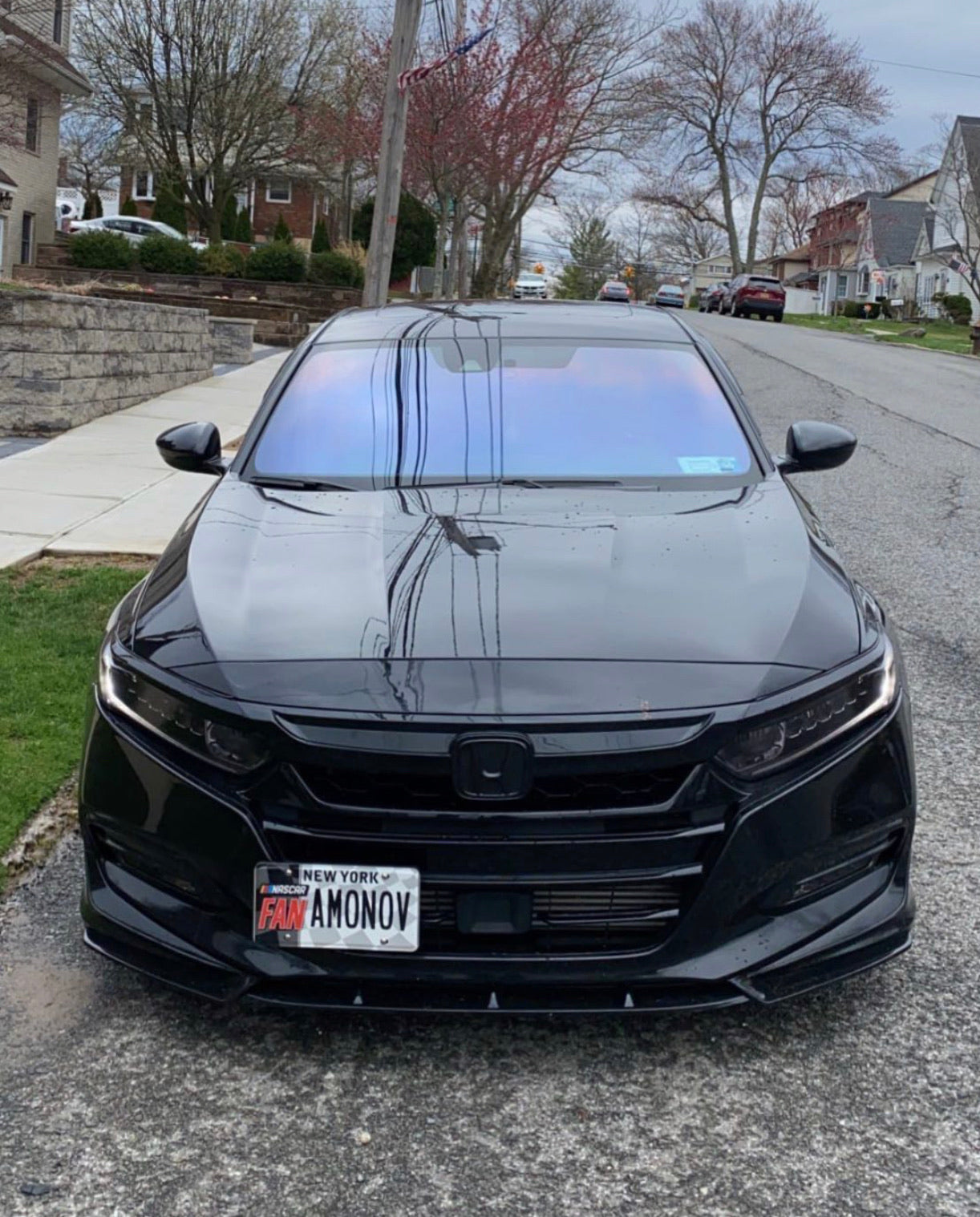 Front view of a black Honda Accord with Omnique IOLITE tint, giving off subtle blue and purple reflections.