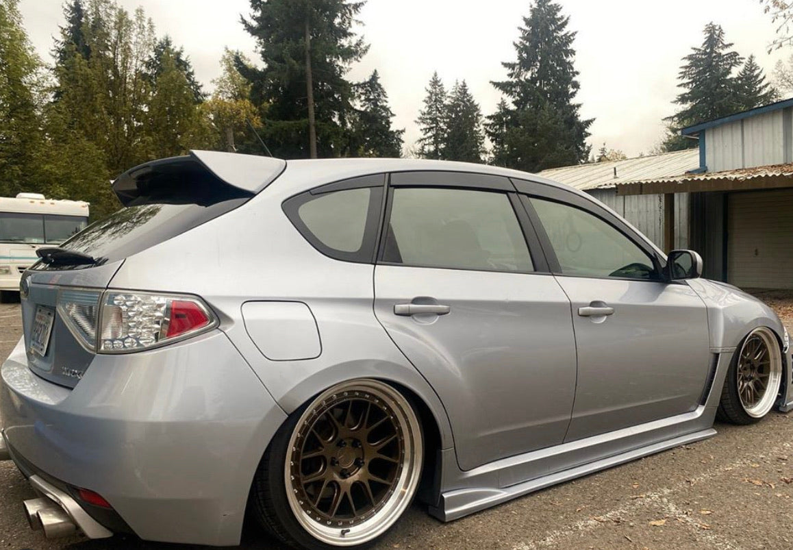 Silver Subaru hatchback with Omnique's Nebula Black tint, enhancing the car’s stylish appearance.