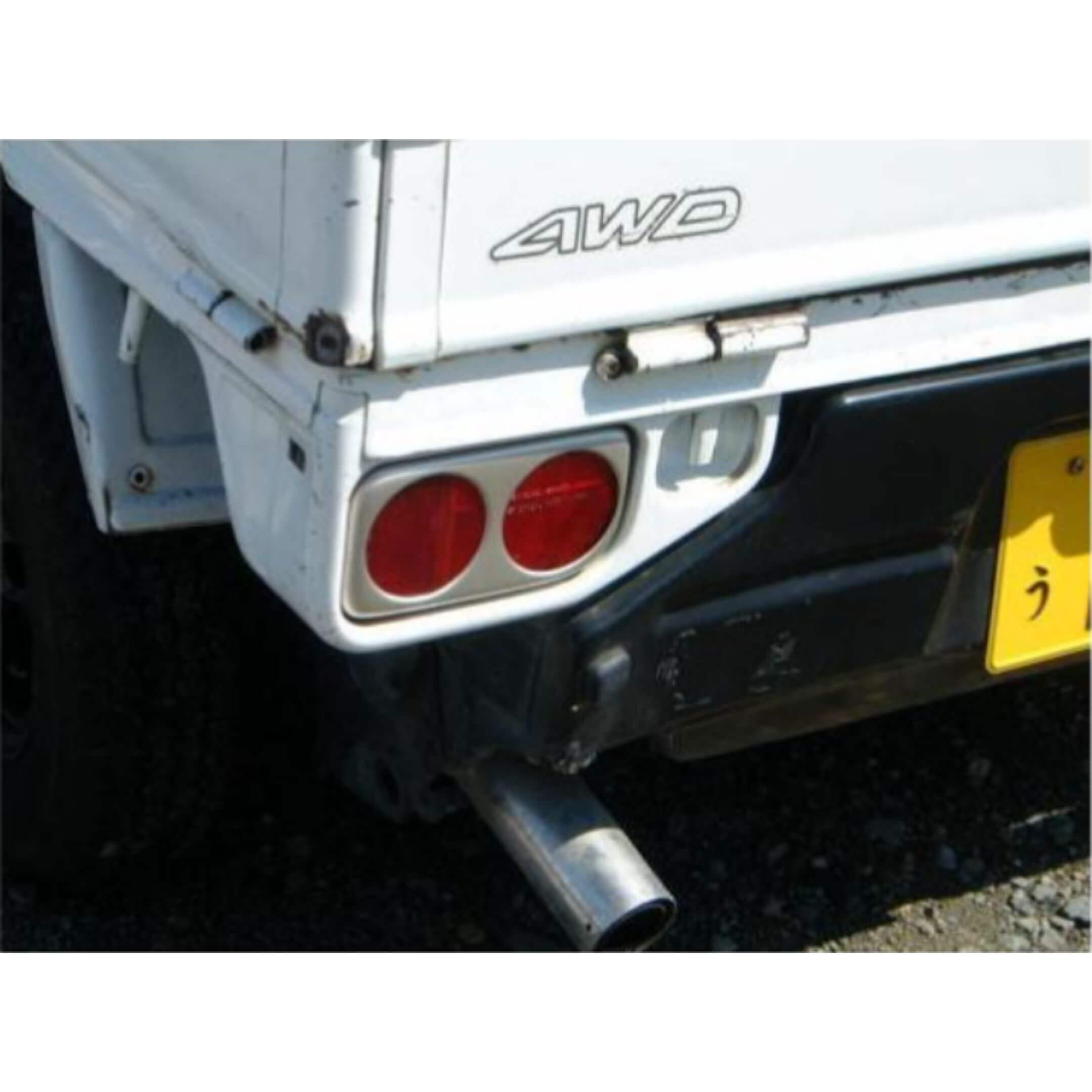 Fiberglass Taillight Garnish Cover in racing style for Subaru Sambar Wagon TW1, TW2 models (1999-2012) featuring dual round taillights and AWD badge.