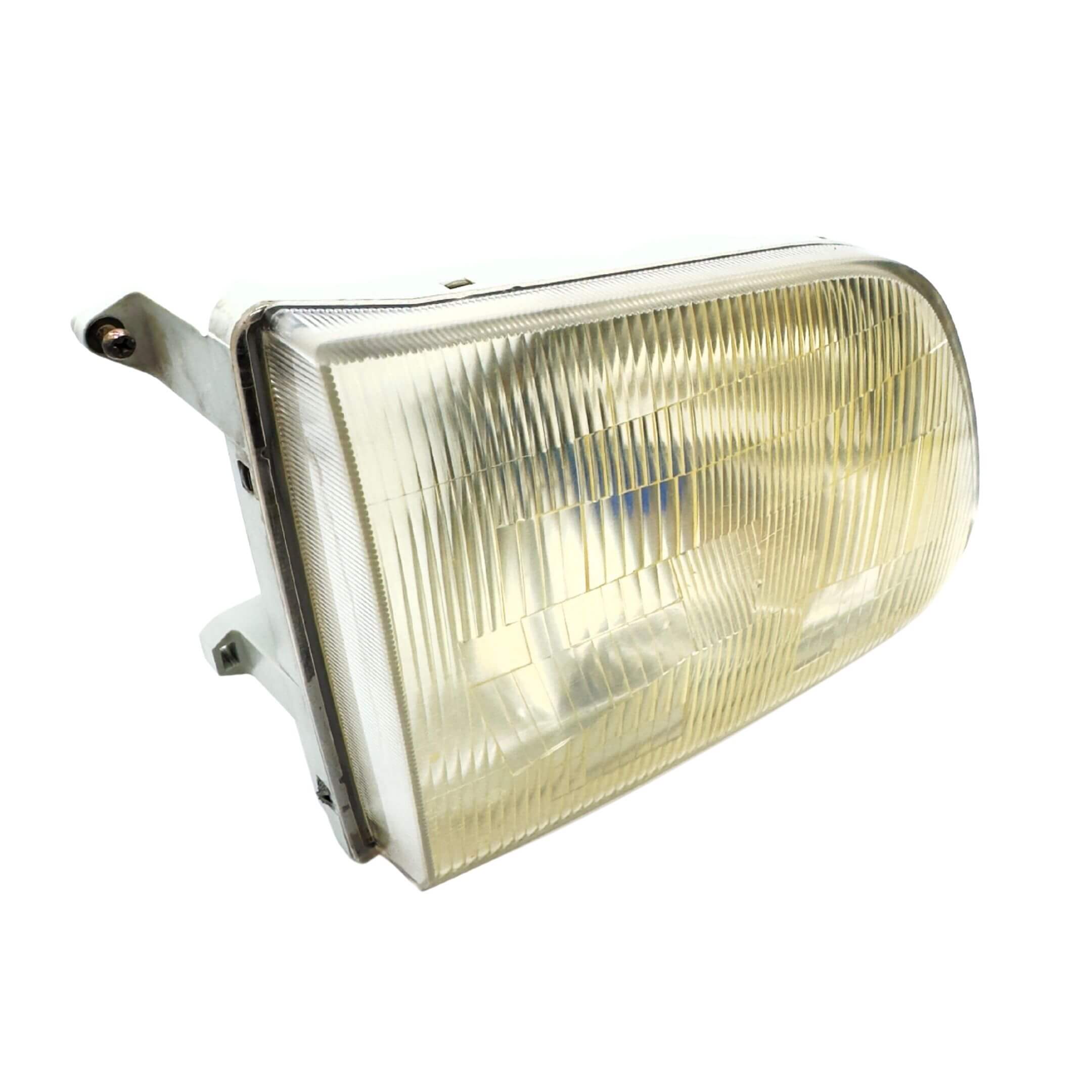 Used right headlight for Subaru Sambar Truck TT1, TT2 models (2002-2012) with clear lens and mounting bracket.