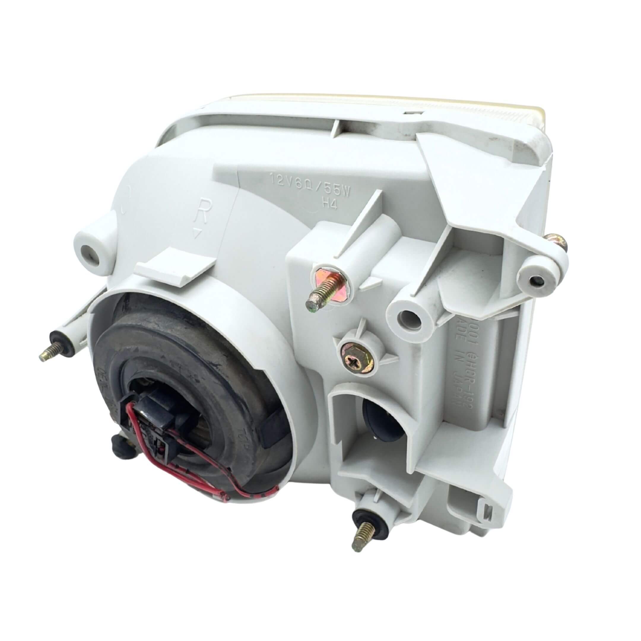 Used right driver side headlight for Subaru Sambar Truck TT1, TT2 models (2002-2012) featuring durable construction and mounting hardware.