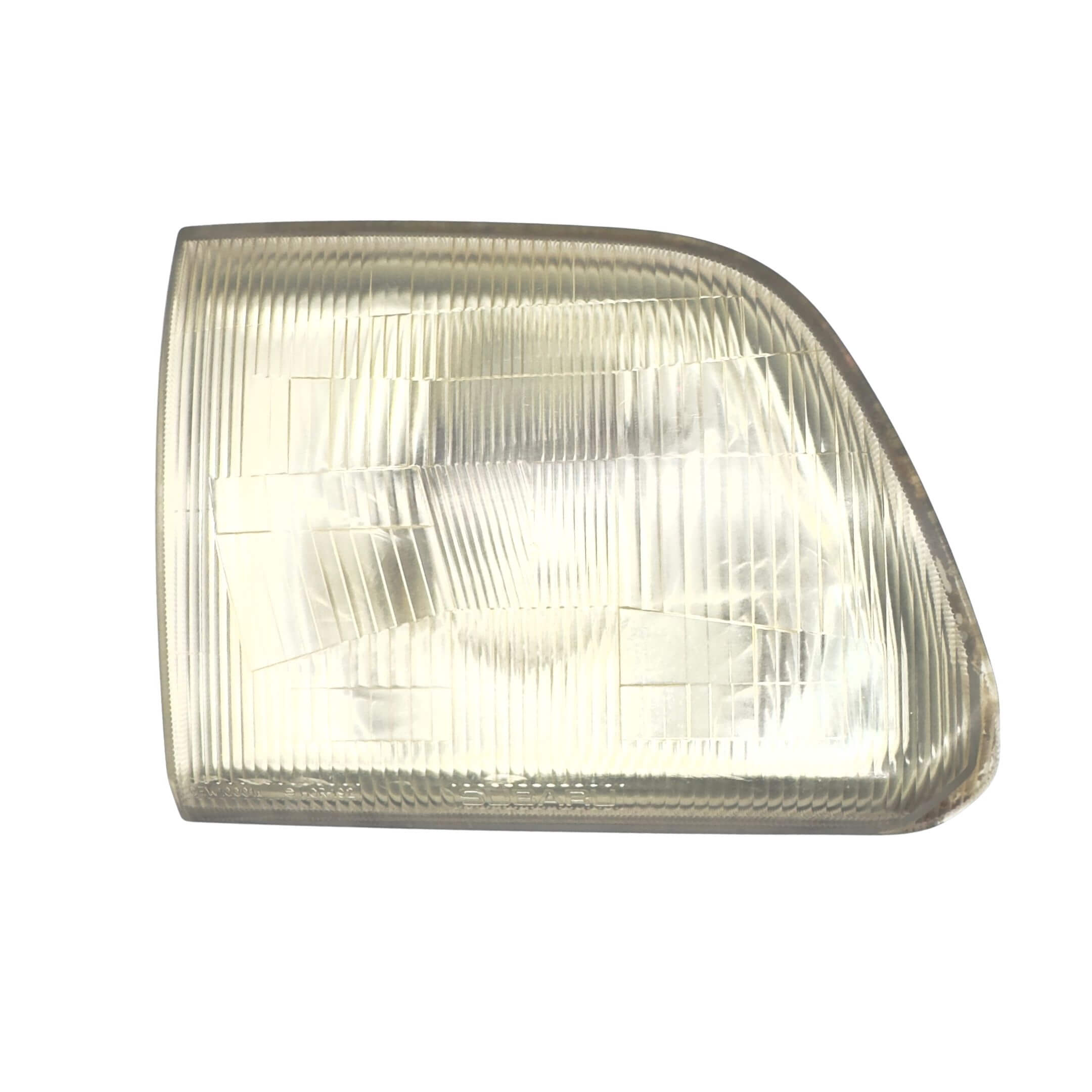 Used left passenger side headlight for Subaru Sambar Wagon TW1, TW2 models (2002-2012) featuring a clear, textured lens.