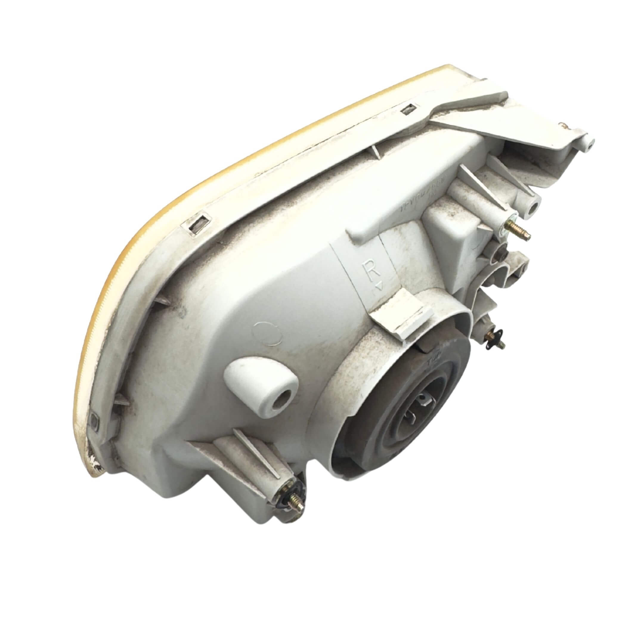 Used left passenger side headlight for Subaru Sambar Truck TT1, TT2 models (2002-2012) featuring a durable housing and mounting points.