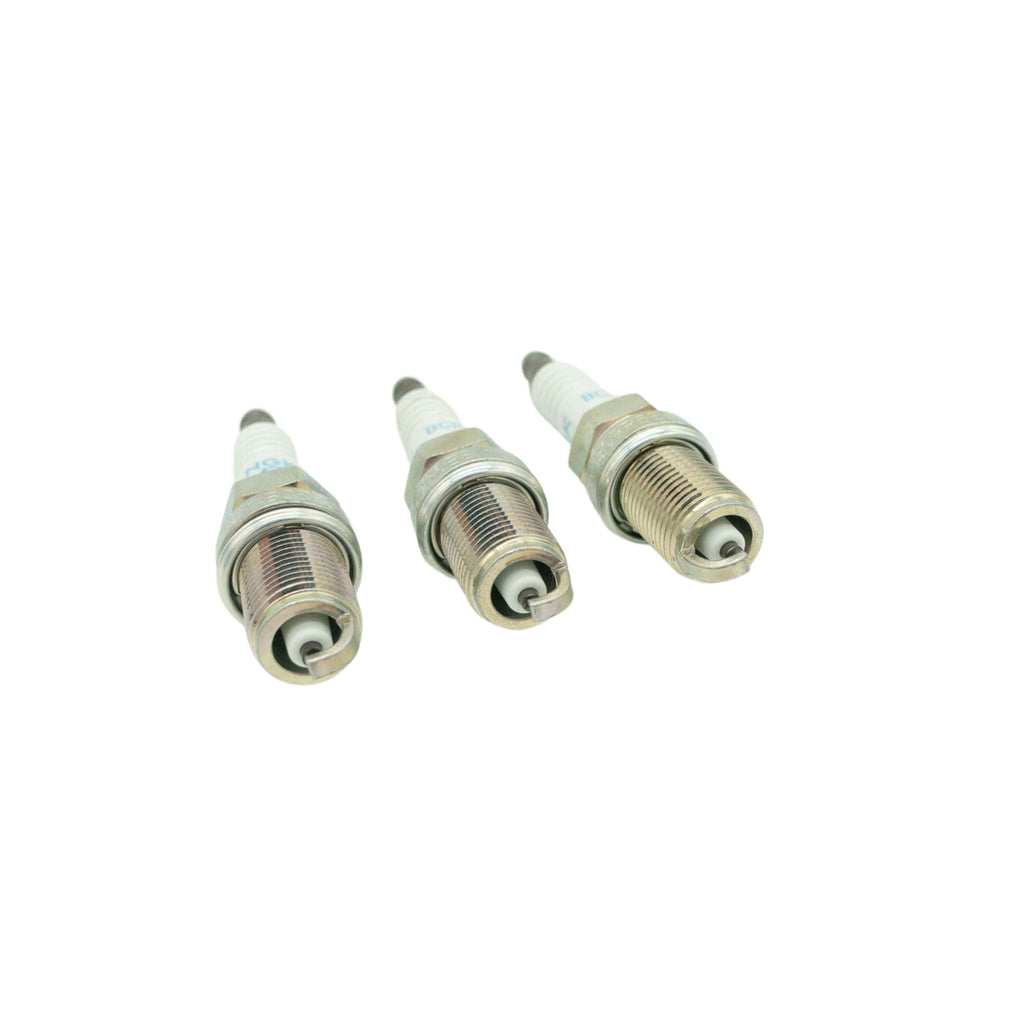 Close-up of three spark plugs for Honda Acty Truck HA3 HA4 1990-1999 models isolated on white background, showing high-quality electrode and threading detail for efficient ignition
