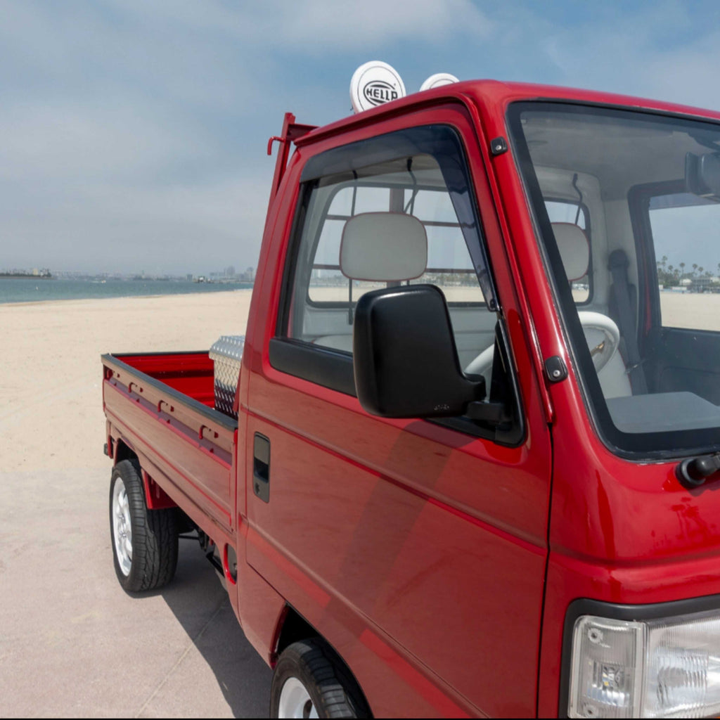 Installed rain guards on Honda Acty Truck red model, enhancing ventilation and rain protection