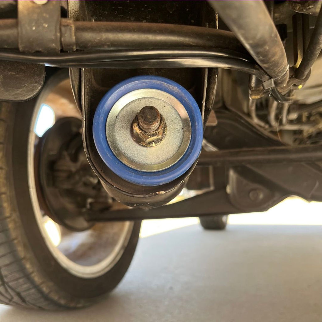 Honda Acty HA3, HA4 Strut Rod Bushing in situ, showing new bushing installation on truck suspension system, enhancing steering precision and ride comfort.